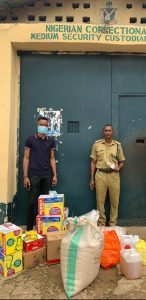 Comrades Fejiro Oliver (left) presenting some of the items at Uyo, Akwa-Ibom State.